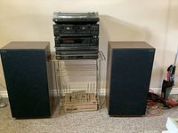 Stacked stereo components and speakers on rack