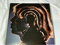 Front cover of The Rolling Stones Hot Rocks 1964-1971 vinyl record album showing stylized layered profile silhouettes of band members.