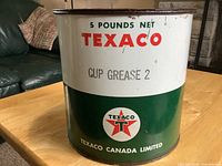 Front view of vintage Texaco lubricant can showing '5 Pounds Net Texaco Cup Grease 2' and Texaco logo.