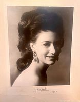 Close-up of the black and white photographic portrait of Princess Margaret showing her head and shoulders, wearing large drop earrings, signed 'Margaret 1967' below.