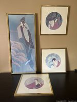 Four Art Deco style framed art prints arranged, showing the sizes and artwork details.