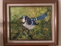 Close-up of the framed painting showing the blue jay bird on a leafy branch with signature by Paul Duff.