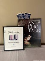 Two Hudson's Bay history books displayed side by side with two small 'Explore Our History' booklets tucked behind.