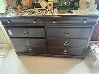 Front view of the dresser showing eight drawers with silver ring pull handles and two smaller top drawers with round knobs