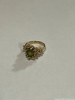 Top view showing oval green stone and textured gold setting