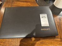 Top view of Lenovo laptop closed, showing Lenovo logo and MaxSold sticker.