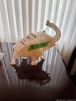 Side view of the carved onyx elephant figurine showing its size and form with natural veining in the stone.