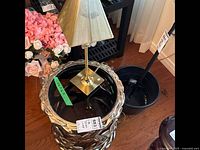 Full view of side table with lamp on top, showing metal frame and smoky glass top