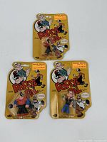 Three sealed Popeye Pal action figures in original blister packaging, including Popeye, Bluto, and Olive Oyl.