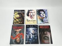 Six graphic novels laid out on a white surface showing all the covers: Witchblade, Kabuki, The Unknown, Halo: Invitation, Hack/Slash My First Maniac.