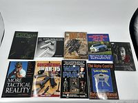 9 assorted magazines laid out on white background including firearms, tactical, military, and car topics