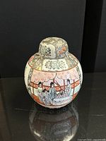 Front view of the closed vase showing painted figures and floral motifs.