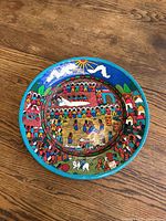 Top-down view showing full colorful scene on round ceramic plate