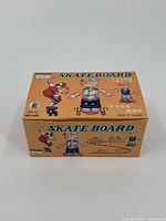 Closed view of the box showing the product branding, model number, and Popeye illustration indicating skateboard mechanical toy, with text in English and Chinese.