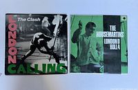 Photo showing both vintage vinyl albums side by side, featuring The Clash on left and The Housemartins on right.