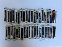 Overview of approximately 40 vintage leather watch straps arranged in rows inside plastic sleeves, showing variety in style and color.