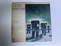 Front cover of vintage Cactus Restrictions vinyl record album showing surrealist artwork of headless suited figures in a barren landscape.