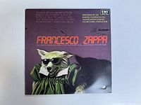 Front cover of the Francesco Zappa vinyl record album featuring a dog in sunglasses and green clothing.