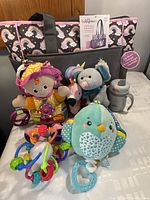 Full lot showing Babyboom diaper bag, several baby toys (Lamaze, Skip Hop), Slumberkins plush, Scentsy mouse, and Thermos bottle