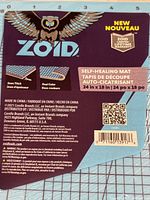 Close-up of product packaging showing ZOID brand, dual color design and self-healing feature, with owl logo and product details.