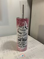 Front view of 20oz skinny tumbler showing glitter pink design and childcare themed text.