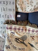 Close-up image showing part of the alphabet blanket and floral woven throw fringe detail.