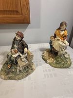 Two vintage Naturecraft stonecraft figurines placed on a table, showing both items clearly