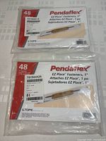 Photo showing two sealed packages of Pendaflex EZ Place Fasteners, 48 count, 1 inch each, front label visible.