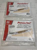 Two brand new sealed packages of Pendaflex EZ Place 1 inch self-adhesive fasteners, each containing 48 fasteners.