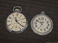 Two vintage pocket watches, Waltham Autocrat with crystal intact and Belain pocket watch with missing crystal showing dial with large black numerals and engraved metal case.