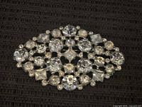 Front of the vintage rhinestone brooch showing clear stones in silver-tone setting