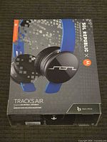 Box of Sol Republic Tracks Air wireless noise-isolating headphones showing product image and logos