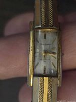 Close-up photo of the vintage Seiko ladies watch dial showing the rectangular glass crystal, gold-tone case, and 'Fine Seiko' logo text with 'Diashock 17 Jewels'.