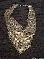 Gold-tone mesh vintage Whiting and Davis necklace laying flat styled to show shape and clasp closure.