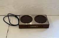 Front angled view of Bunnomatic double warmer plate with power cord and switches visible.