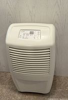 Front view of white Whirlpool dehumidifier with vent grilles and control panel