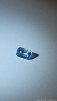Close-up of the octagon cut Swiss Blue Topaz showing light blue color and clarity under white lighting.