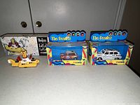 Four Corgi Beatles diecast vehicles including Yellow Submarine and three boxed cars