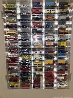 Front view of clear acrylic display case fully loaded with 70 Matchbox vehicles