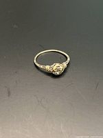 Top-down view of ring showing filigree design and empty center setting