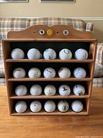 Front view of the wooden golf ball rack filled with 25 golf balls.