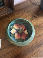 Top view of small green Moorcroft bowl showing the detailed inside floral design colors and textures.