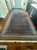 Full view of entire rug laid out on hardwood floor beneath entryway and kitchen island