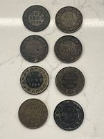 Top view of the eight coins arranged in two vertical columns, showing reverse sides with 'ONE CENT CANADA' and dates 1859, 1896, 1900, 1903, 1911, 1916, 1919, 1920.