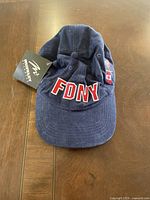 Front view of navy blue FDNY hat showing the embroidered FDNY letters on the front panel.