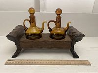 Image showing the full cruet set on its wooden stand with a 12-inch ruler for scale.