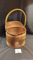 Front angle showing copper coal scuttle and brass handle with visible patina and dents.