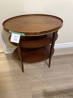 Full view of the vintage mid-century modern wooden end table/nightstand showing three tiers and overall structure.