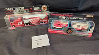 Photo showing two boxed Matchbox Detroit Red Wings collectibles, a white and red truck with trailer (2000 Limited Edition White Rose) and a dual vehicle team collectible set (NHL 75th Anniversary)
