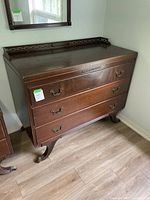 Front and side view of wooden dresser showing overall condition and design